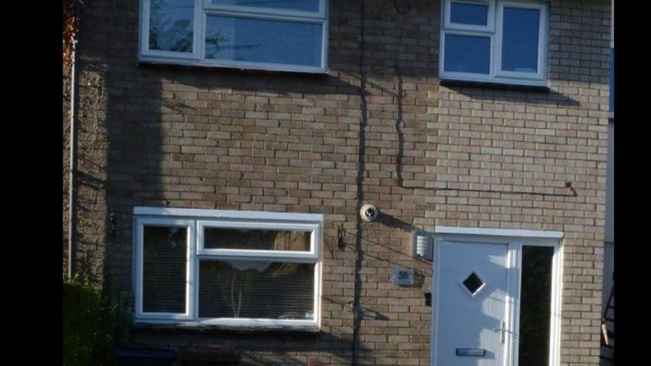 David Carrick's house is made of cream bricks and looks like an ordinary property in a residential street. It has a white door and windows with white panes.