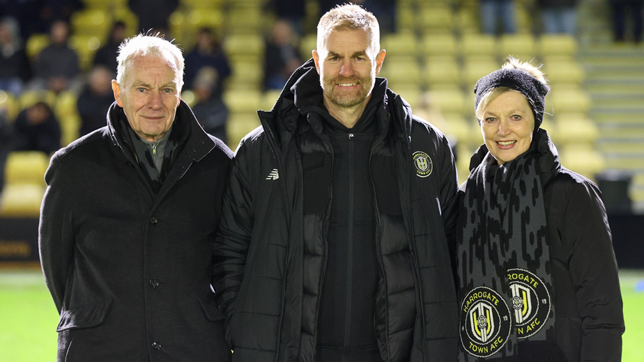 Harrogate Town owner Irving Weaver (left) and his wife Dorothy along with their son Simon pose for a photograph on the pitch at the club.