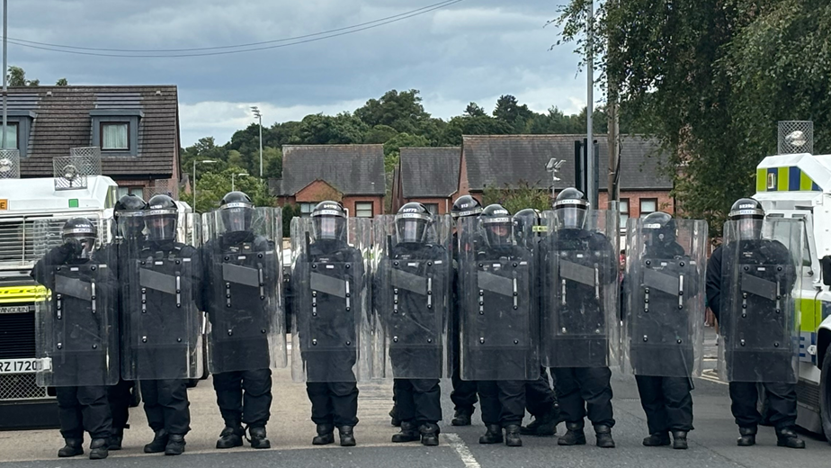 Police with riot shields in the Ormeau Road area of south Belfast