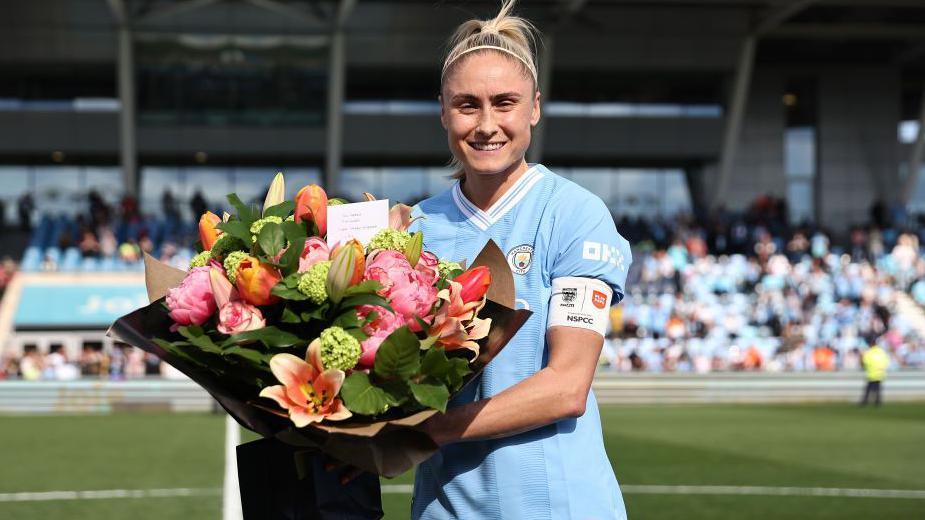 Steph Houghton with a bunch of flowers before her final game