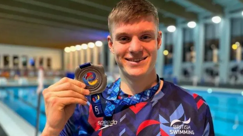 Ollie Morgan holding a medal