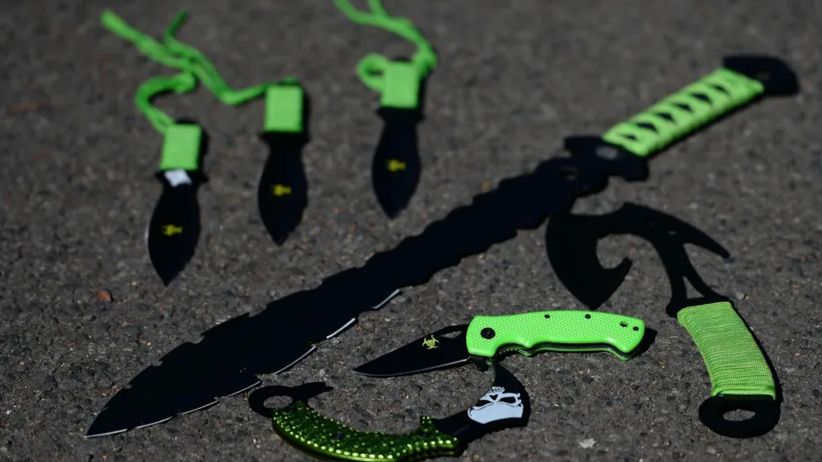 Zombie knives, with green handles, on the floor 