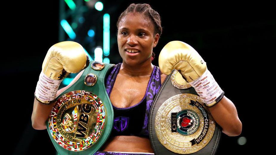 Caroline Dubois posing with the WBC and IBO belts