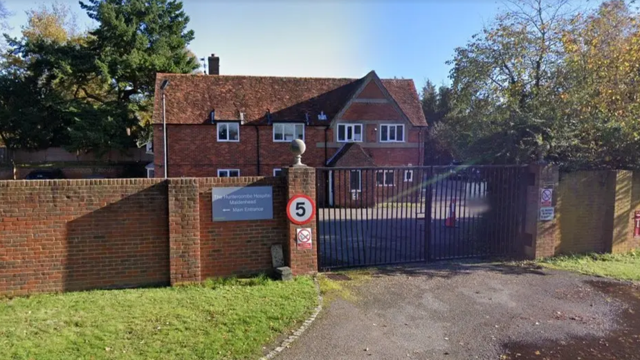 The hospital, which was a two-storey building, behind a black gate.