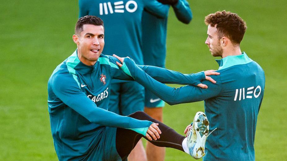 Cristiano Ronaldo warming up with Diogo Jota