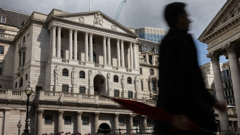 Man walks in front of Bank of England building