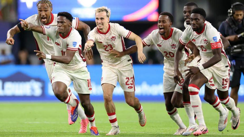 Canada players celebrating after their penalty shootout win