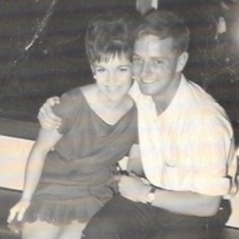 Ian and his wife Robyn are pictured in a black and white photo. They are sitting together. Ian and his arm around Robyn's shoulder.