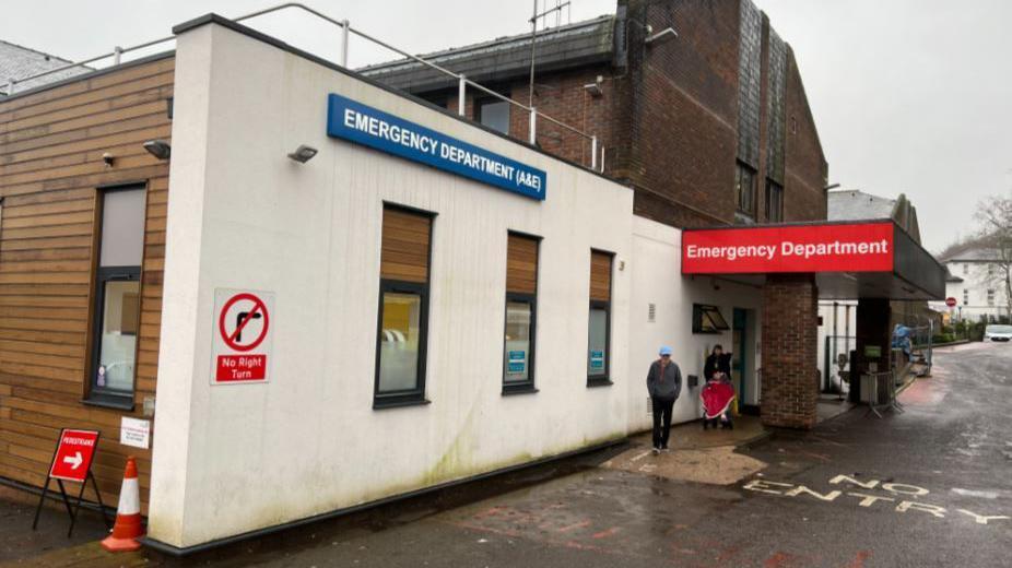 Winchester's Royal Hampshire County Hospital A&E department, with a white facade and a red "Emergency Department" sign.