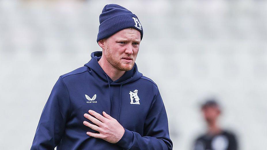 Dan Mousley in his Warwickshire training gear goes through a warm-up ahead of the start of play