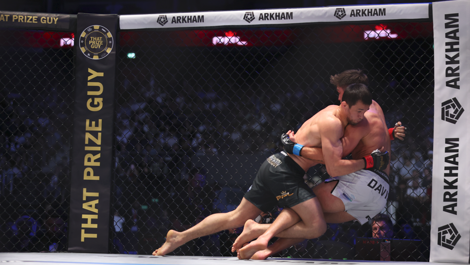 Usman Nurmagomedov lands a takedown on Alfie Davis