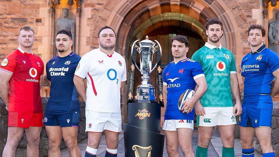 Wales' Dewi Lake (L), Scotland's captain Sione Tuipulotu (2L), England's Jamie George (3L), France's Antoine Dupont (3R), Ireland's Caelan Doris (2R), and Italy's Michele Lamaro pose with the Six Nations trophy.