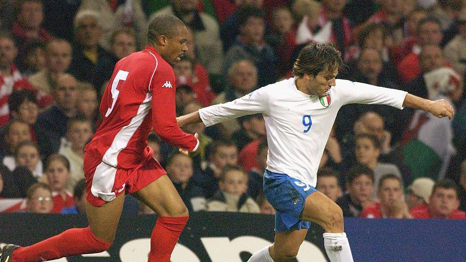 Vincenzo Pirlo holds off Danny Gabbidon during the Euro 2004 qualifying match