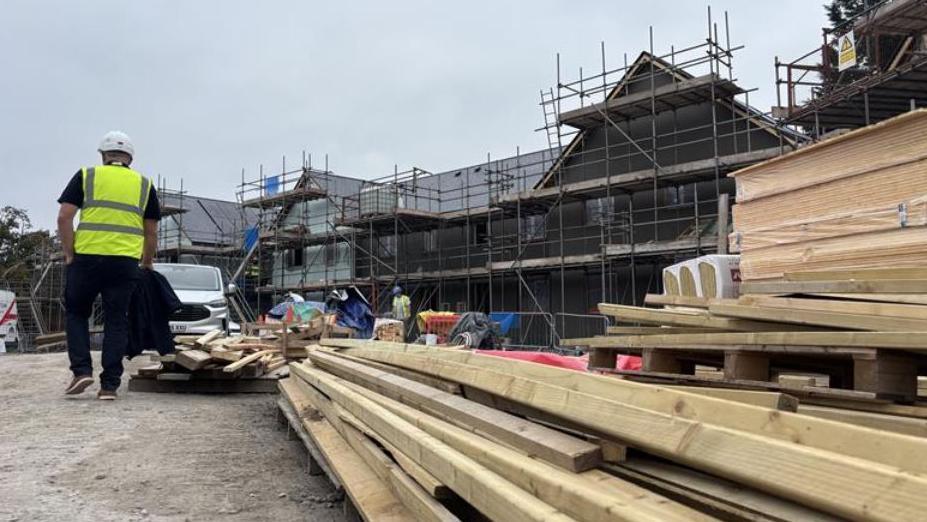 Wood piled up with houses being built