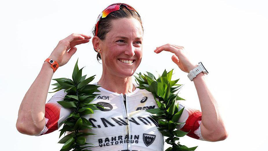 Kat Matthews smiling on the podium.