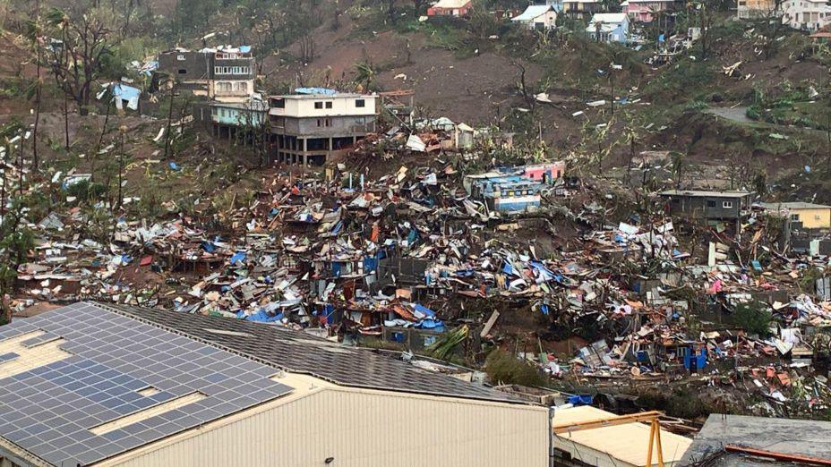 Destroyed homes and debris line a hillside in Mayotte