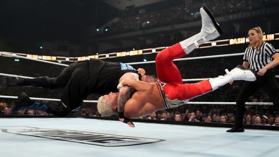 Cody performing a wrestling move in the air