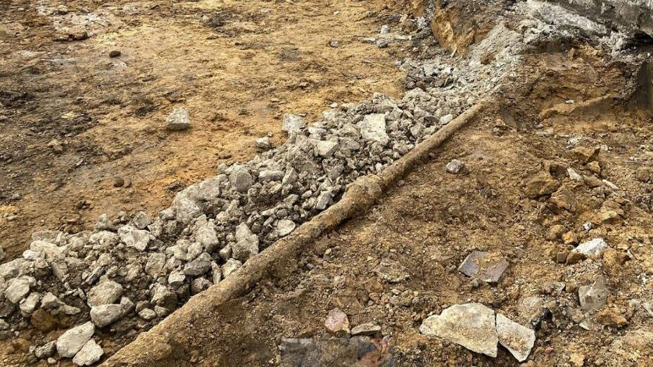 The site of an archaeological dig in Richmond, with stones and fragments scattered across the ground.