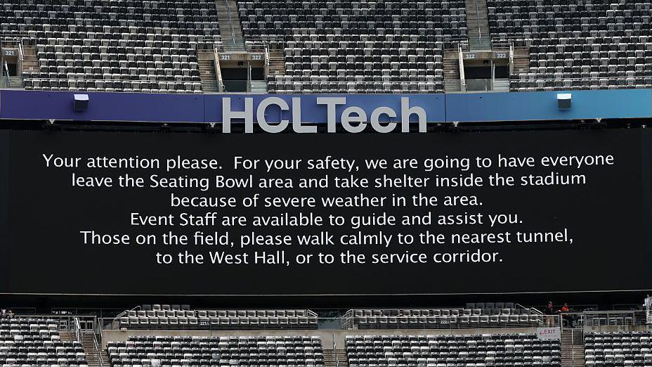 A sign asking supporters to move inside due to severe weather conditions