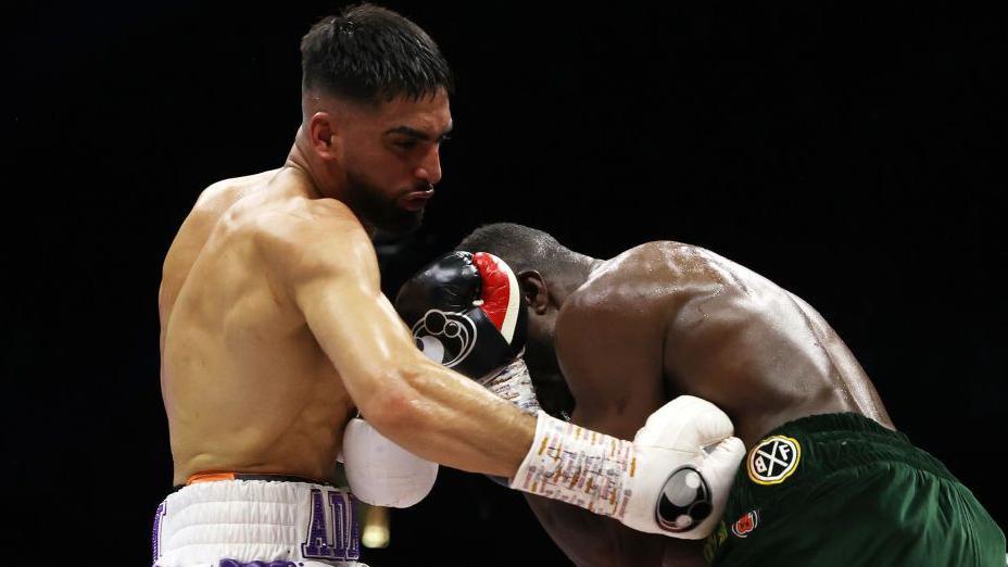 Adam Azim throws a body shot at Ohara Davies