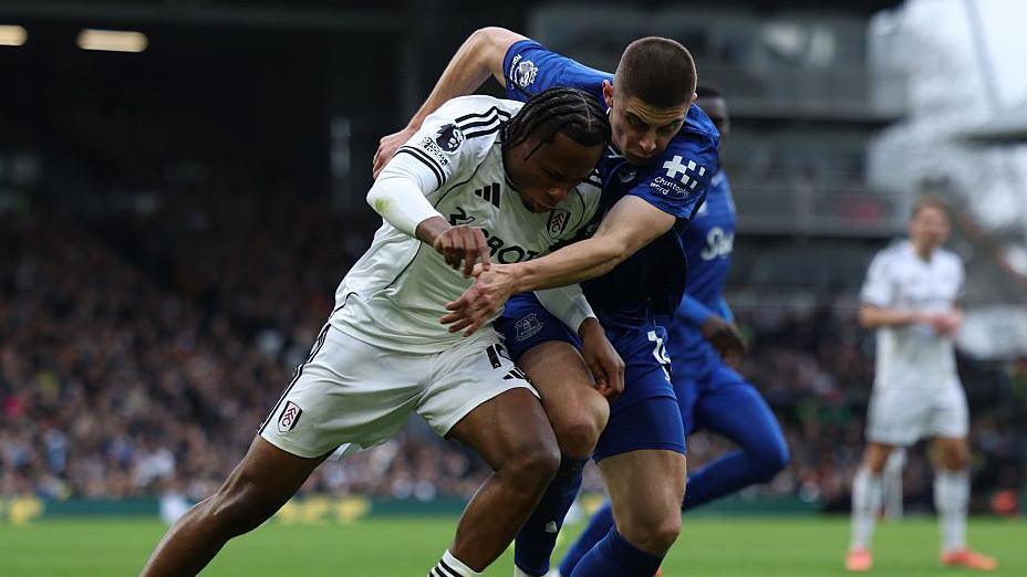 Everton full-back Vitalii Mykolenko (right) battles for the ball in the Premier League game against Fulham on 7 February 