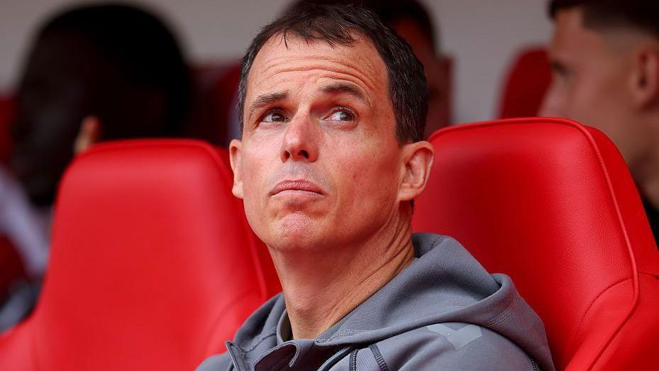 Sunderland manager Regis Le Bris looks up while sat in the dugout