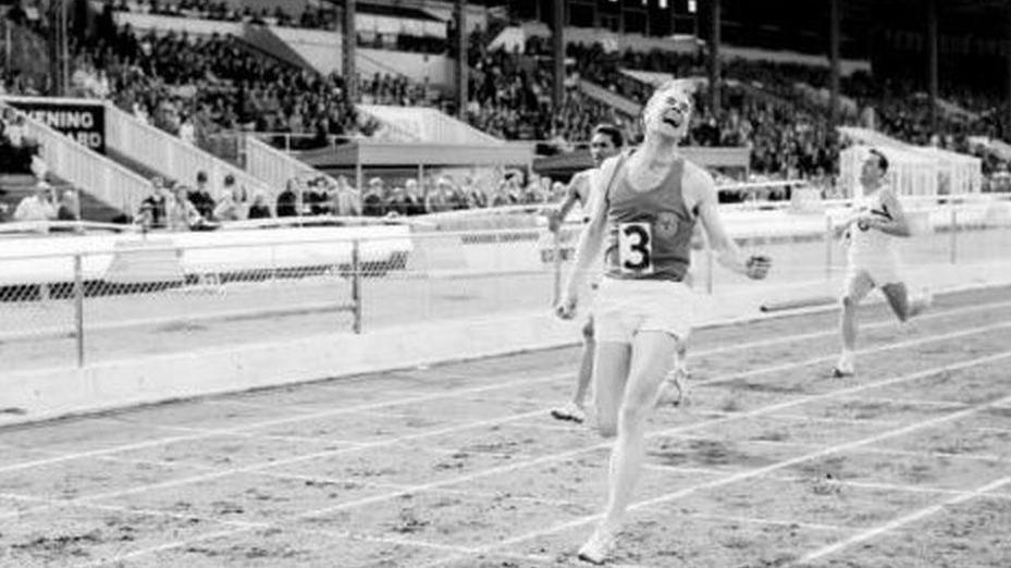 Menzies Campbell running.  This is a black and white photo of Campbell competing in a sprint event. He is wearing the number three and grimacing with effort.