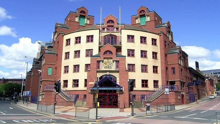 Leeds Magistrates' Court - a five story court house built out of brick and stone at the junction of two roads