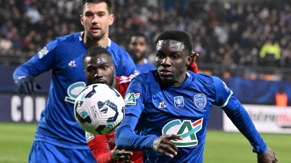 Abdoulaye Kante challenges for the ball during a match
