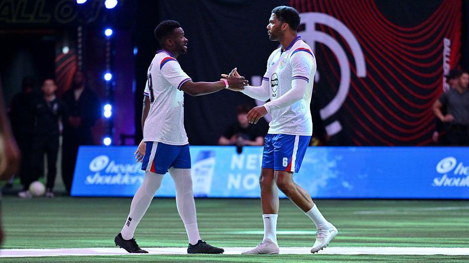 Joleon Lescott (right) shakes hands with a team-mate