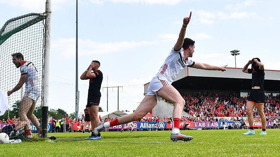 Conall McCaul celebrates as Sam Mulroy's shot ends up in the net