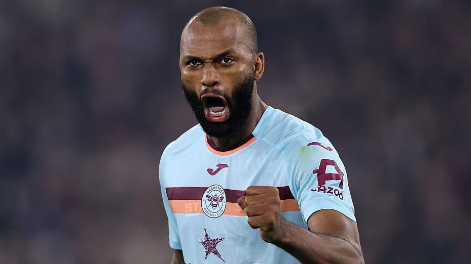 Igor Thiago celebrates with a clenched left fist and passionate facial expression