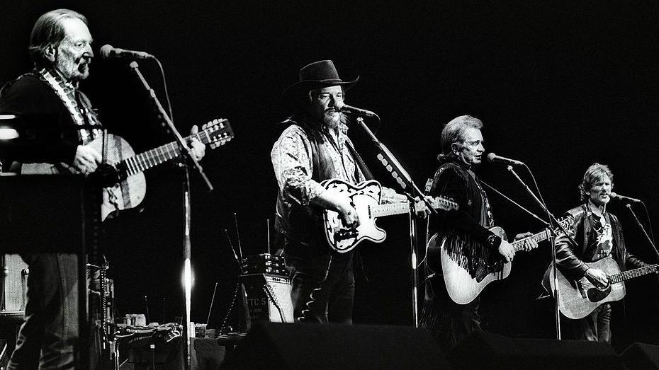 The Highwaymen perform on stage in Ahoy, Rotterdam in 1992 in this black and white photo. Left to right is Willie Nelson, Waylon Jennings, Johnny Cash and Kris Kristofferson