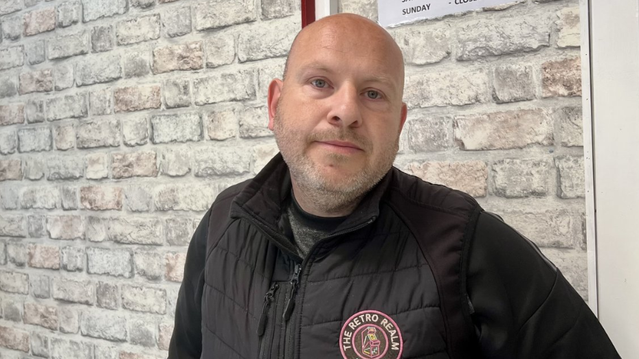 Man looking into the camera with a black jacket.