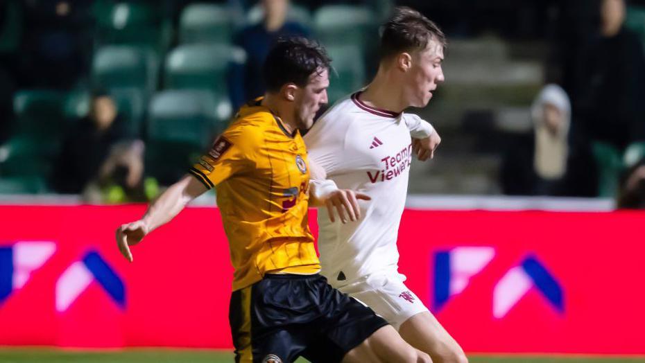 Rasmus Hojlund of Manchester United in action with Ryan Delaney of Newport County during the FA Cup in 2024