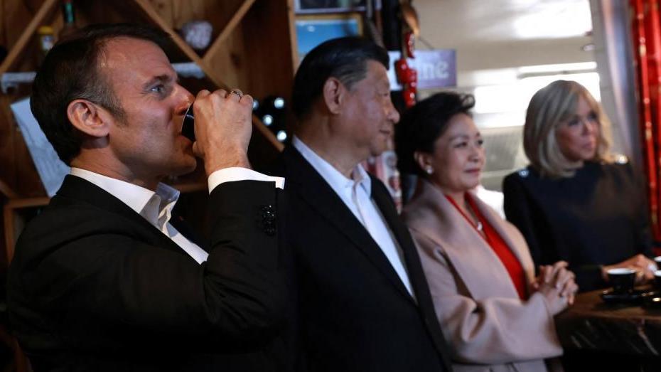 French President Emmanuel Macron drinks coffee in a restaurant with Chinese President Xi Jinping, his wife Peng Liyuan, and Brigitte Macron, on Tuesday, May 7, 2024, at the Tourmalet pass, in the Pyrenees mountains