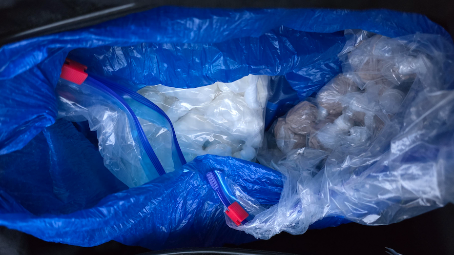 A black holdall with a number of sandwich bags of white power and heroin. 