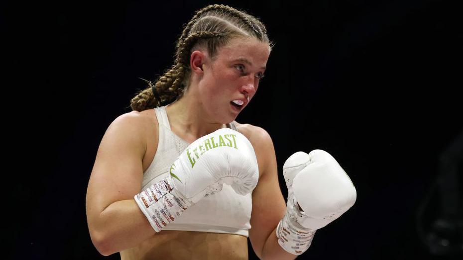 Francesca Hennessy in the ring with white gloves on