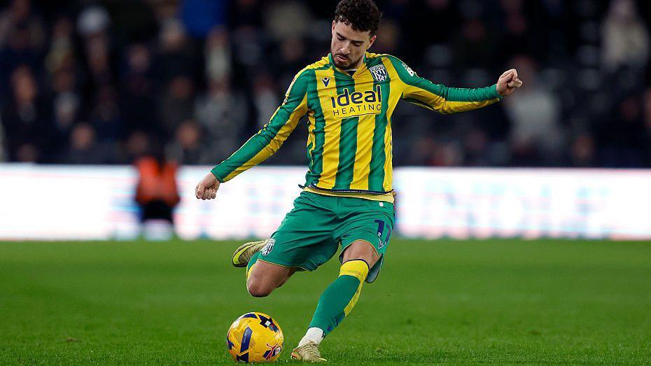 Mikey Johnstone, pictured in a West Brom away kit, plays a forward pass