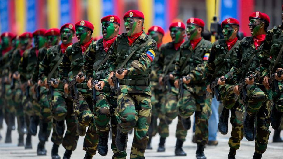 Members of the Venezuelan Army wearing uniforms and red berets.