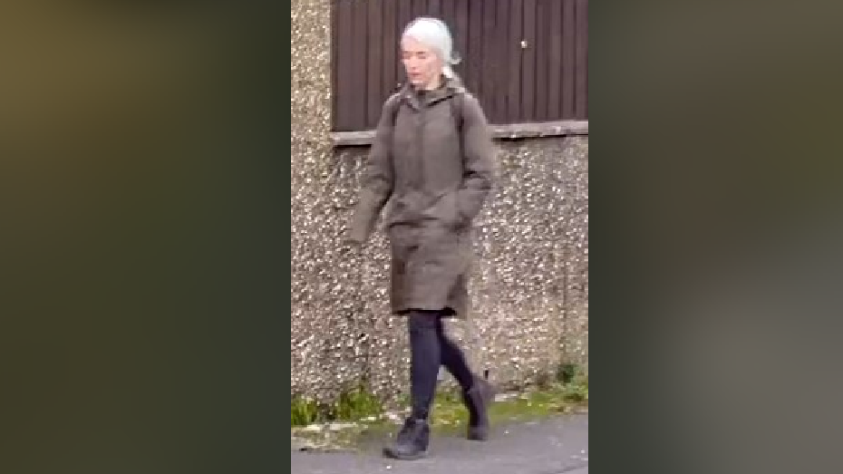 CCTV of Joanne Jones walking in a street wearing a dark green coat, black rucksack, leggings, and walking boots