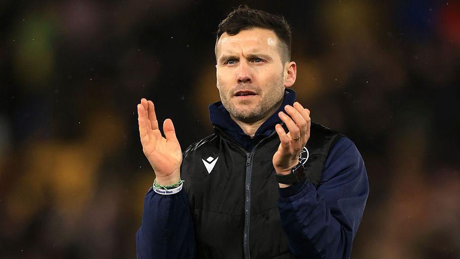 Walsall head coach Mat Sadler claps the crowd after a game