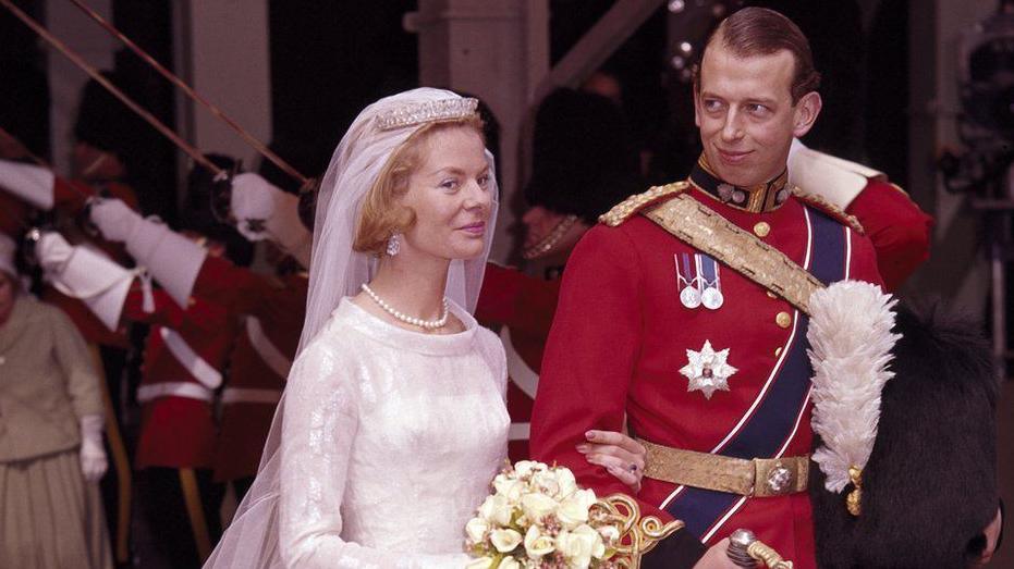 The Duke and Duchess of Kent's wedding at York Minster. The Duke is wearing military uniform and The Duchess has her veil pulled back.