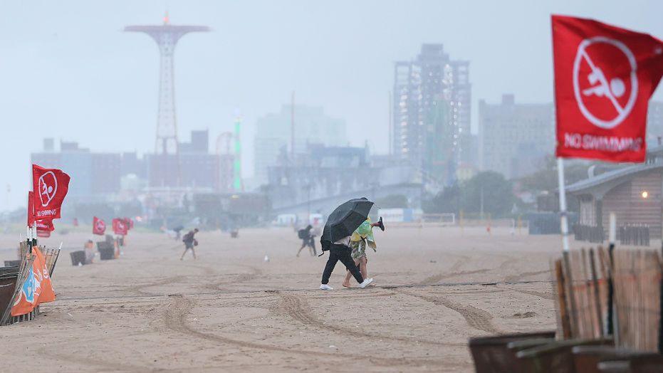 Red "No Swimming" flags are seen in Brighton Beach in Brooklyn, New York City, amid Hurricane Erin on 20 August 2025