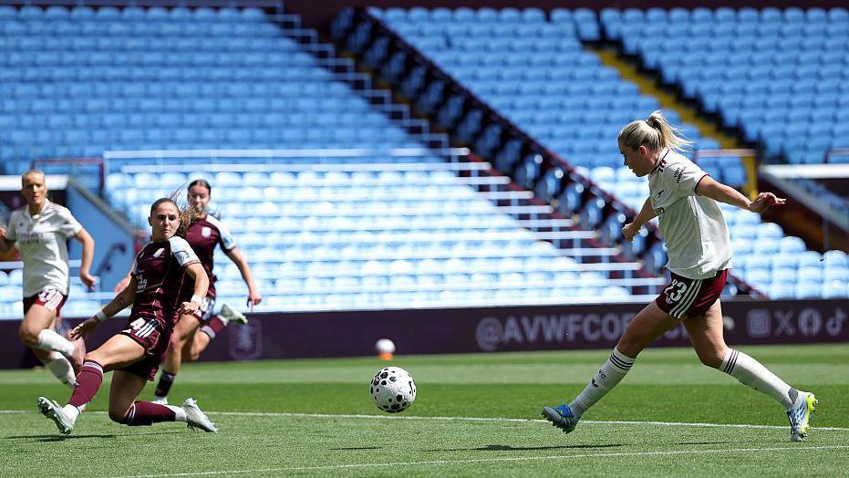 Alessia Russo shoots past a stranded Aston Villa defender