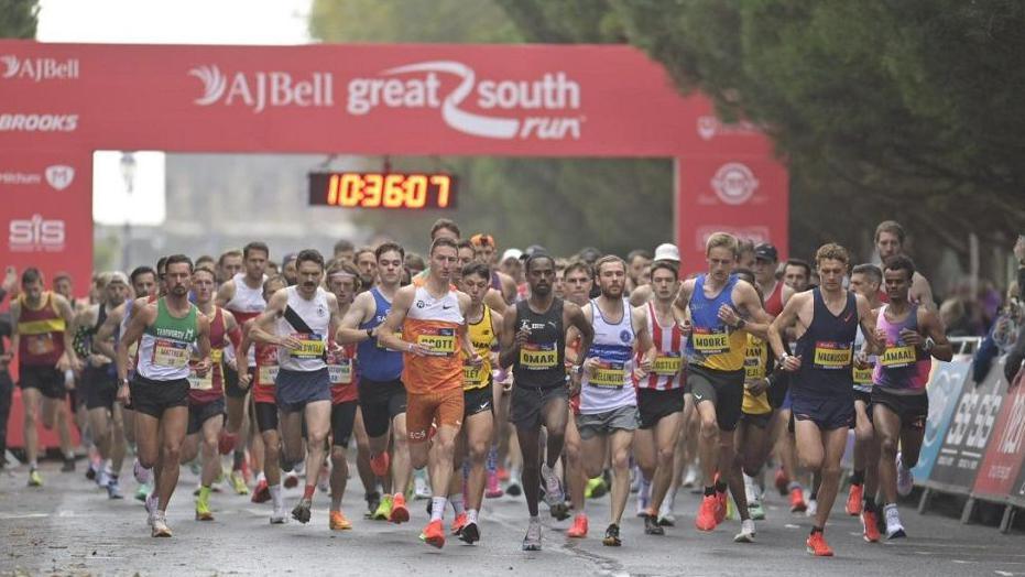 A group of runners at the start line of the race.
