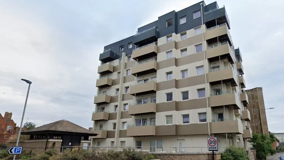 A picture of Nova House with cream and brown cladding. It is a residential tower block with seven floors. 