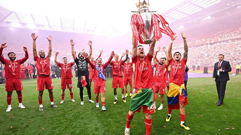 Diogo Jota of Liverpool celebrates with the Premier League trophy as Liverpool are crowned champions for the 2024-25 season