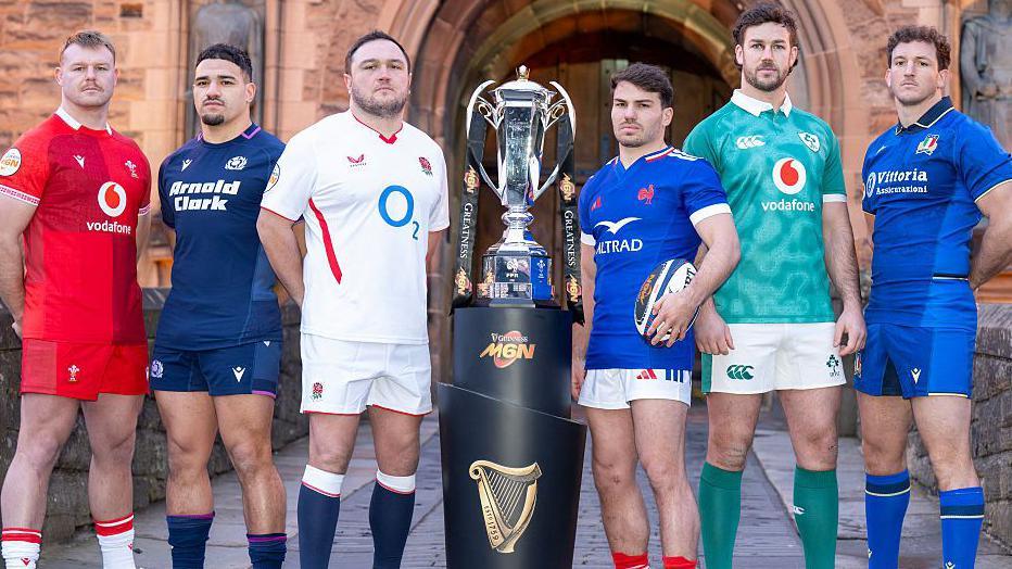 Wales' Dewi Lake (left), Scotland's captain Sione Tuipulotu, England's Jamie George, France's Antoine Dupont, Ireland's Caelan Doris and Italy's Michele Lamaro pose with the trophy during the Six Nations tournament launch in Edinburgh, Scotland