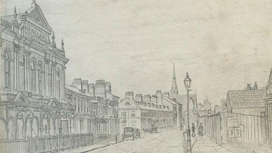A pencil sketch of Hull's Anlaby Road showing a large building in the foreground and a row of terrace house in the background. Two horse and carriages are on the road and a number of people are walking along the pavement